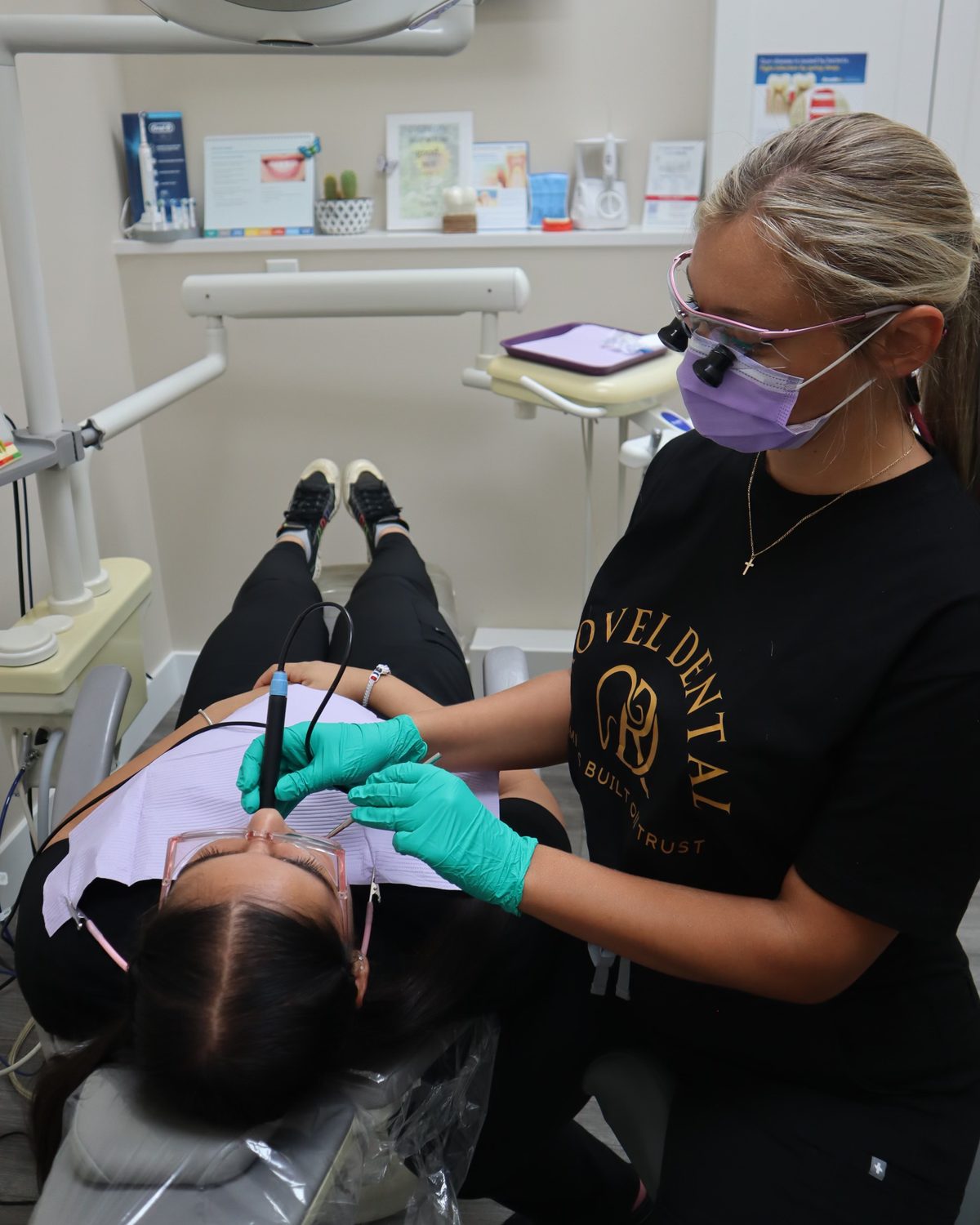 Dental hygienist performing a cleaning at Rovel Dental in Palm Springs, FL